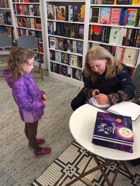 Laura signing girl in purple